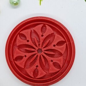 Floral Elegance in Crimson: Artistic Carving on a Disc